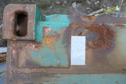 Repair patch on a rusty shipping container