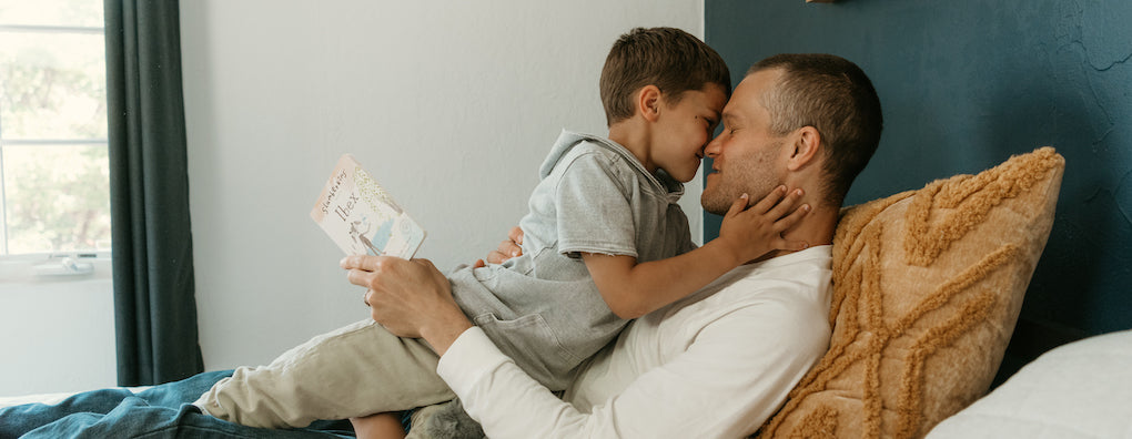 Boy and father reading ibex and embracing