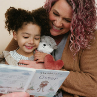 mother and daughter reading otter&#039;s book