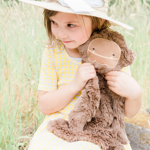 Child holding Bigfoot Snuggler in a field
