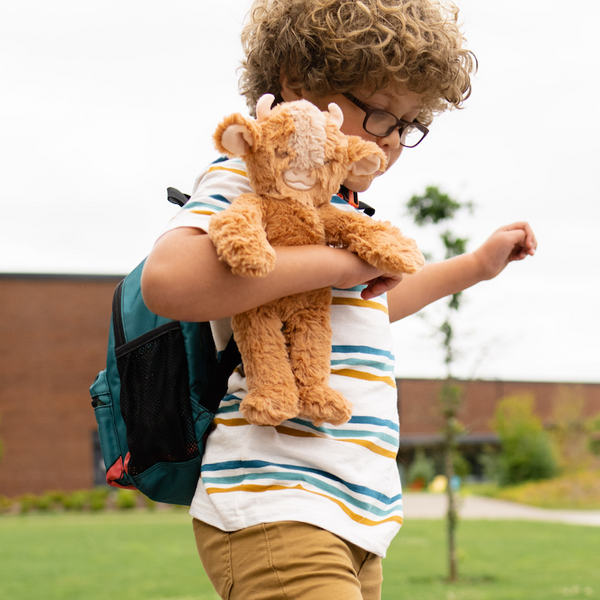 Young child carrying yak kin to school 