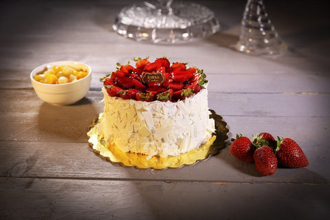 white chocolate cake topped with strawberries