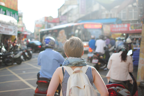 Woman traveler waking down the street in Asia