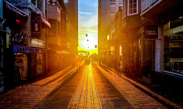 European Street with Sunset coming through 2 buildings at the end.