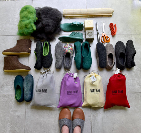BureBure felted shoes models and linen packaging on the ground, flat lay photo