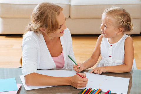 Mother and daughter drawing together