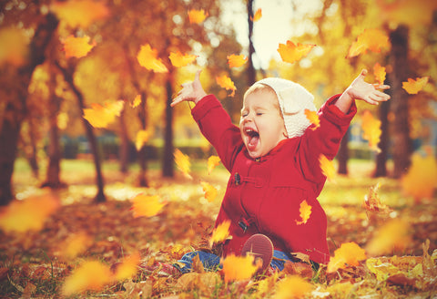 Happy little baby girl child laughing in fall