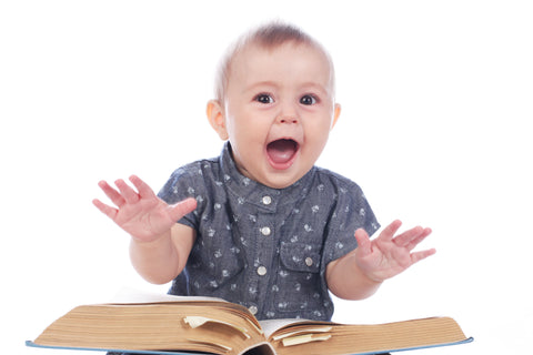 Baby sitting in front of a book