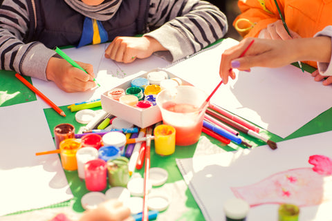 Children creating a colorful reading tracker to encourage them to read