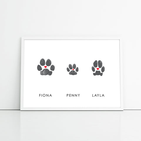 three dog paw prints in white frame