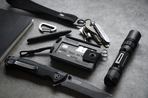 Trayvax Axis wallet surrounded by edc gear