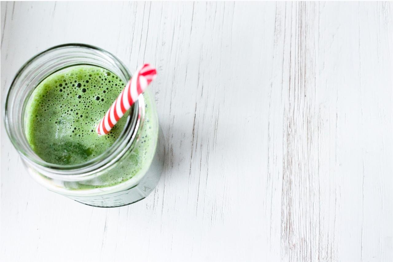 Green smoothie with a red stripy straw