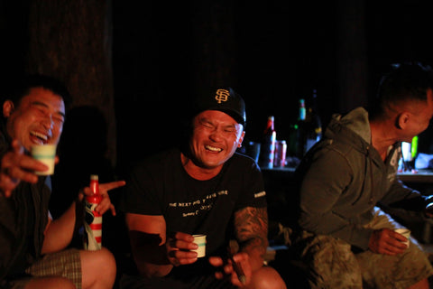 drinking and laughing at camp
