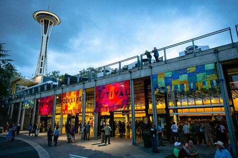 Banners hanging for the Northwest Folklife Festival under the Space Needle.