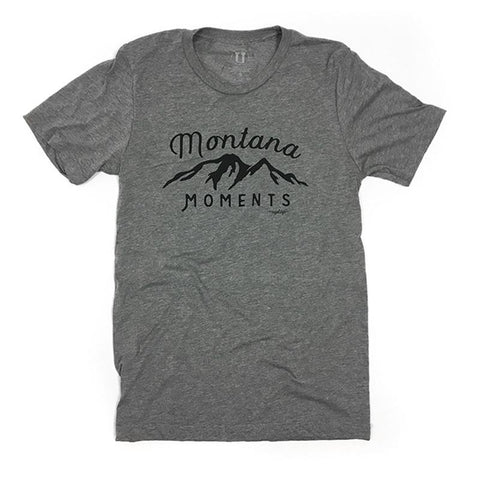 Grey tee shirt with the outline of a mountain in black that says Montana Moments