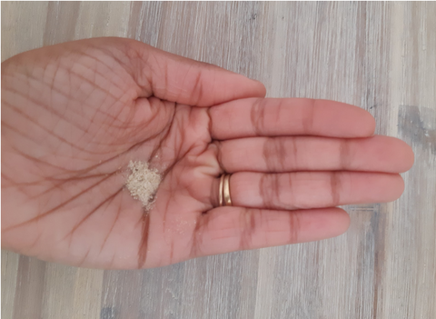 small amount of yellowish powder in a woman's open palm