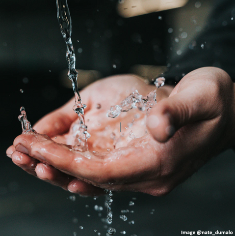 hands with water splashing onto them