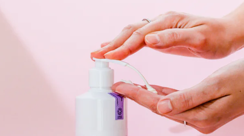woman hands pumping lotion from bottle
