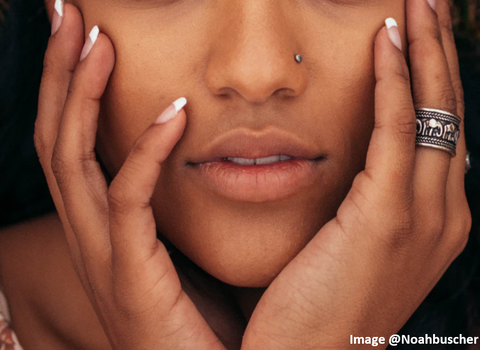 african american woman cropped face picture showing her nose and mouth with both hands cupping the sides of her face