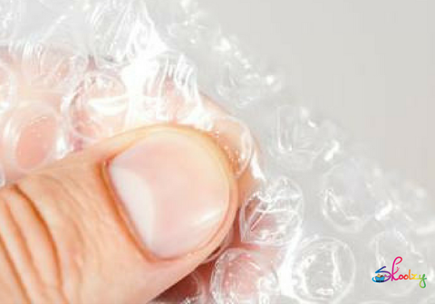 thumb and forefinger pinching bubble wrap