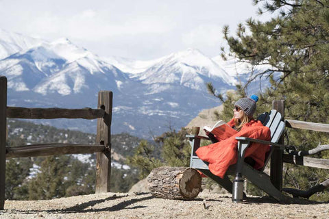 mountain scene with a person sitting in a chair