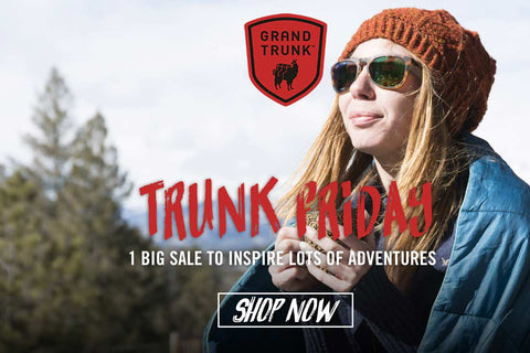 Trunk Friday advertisement featuring a woman in a red beanie, sunglasses, and a blue blanket draped over her shoulders