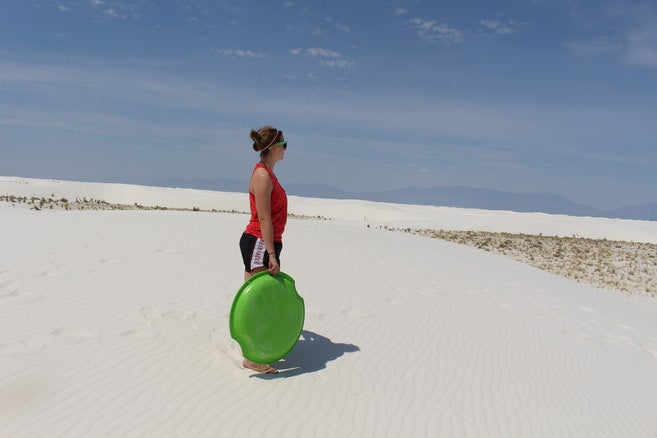 Woman standing in the sand dunes at White Sands National Monument, New Mexico