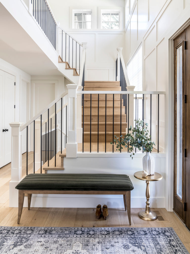 White walls and moulding in a traditional home with natural white oak hardwood on staircase