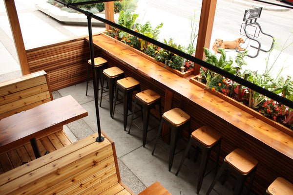 Self-Watering elevated restaurant garden. Cedar raised beds, container gardens, and veggie/vegetable gardens featuring GardenWell sub-irrigation to create wicking beds for growing your own food.