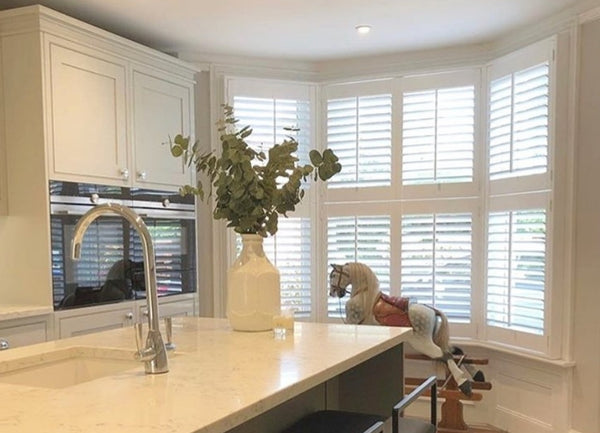 professionally fitted bay window shutters in a modern kitchen