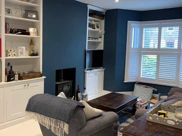 white bay window shutters in a living room in west london