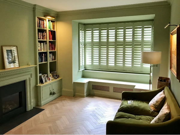 perfect dressing for a bay window with green shutters blending with the surrounding colours