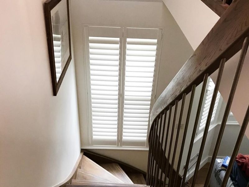 staircase window with closed shutters