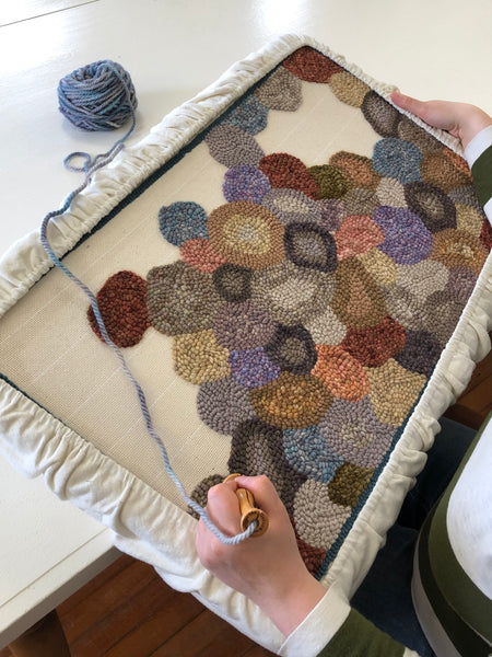 Cotey working on her "Pebbles" rug on the new 15"by26" frame.