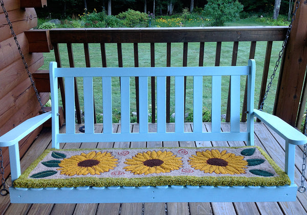 Sunflower Rug on a swing. Designed and punched by Irma Higgins, Ripton, Vermont.