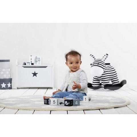 black and white zebra rocker and baby in beautiful monochrome interior