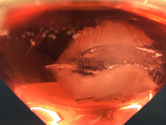 Glass with pink gin and ice