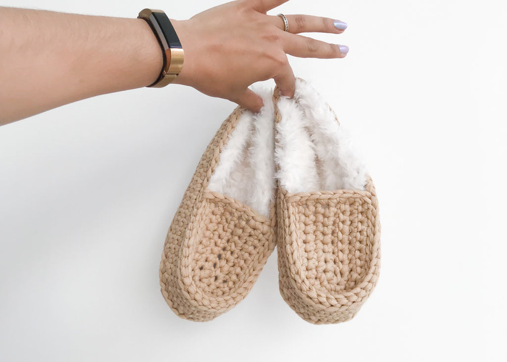 Crochet slippers held in hand