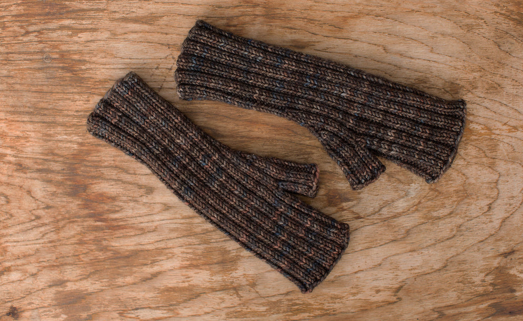 Brown multi-color fingerless mittens/wrist warmers. Handmade by the TOM BIHN Ravelry group for the TOM BIHN crew.