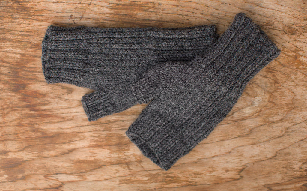 Dark grey fingerless gloves. Handmade by the TOM BIHN Ravelry group for the TOM BIHN crew.