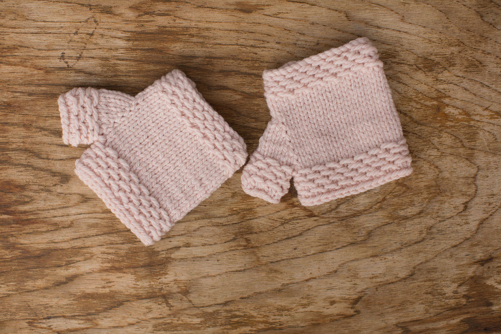 Pale pink fingerless mittens. Handmade by the TOM BIHN Ravelry group for the TOM BIHN crew.