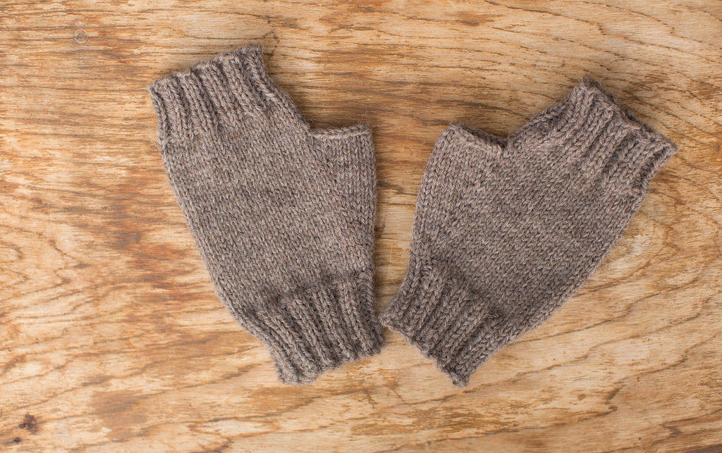 Natural hue fingerless mittens. Handmade by the TOM BIHN Ravelry group for the TOM BIHN crew.