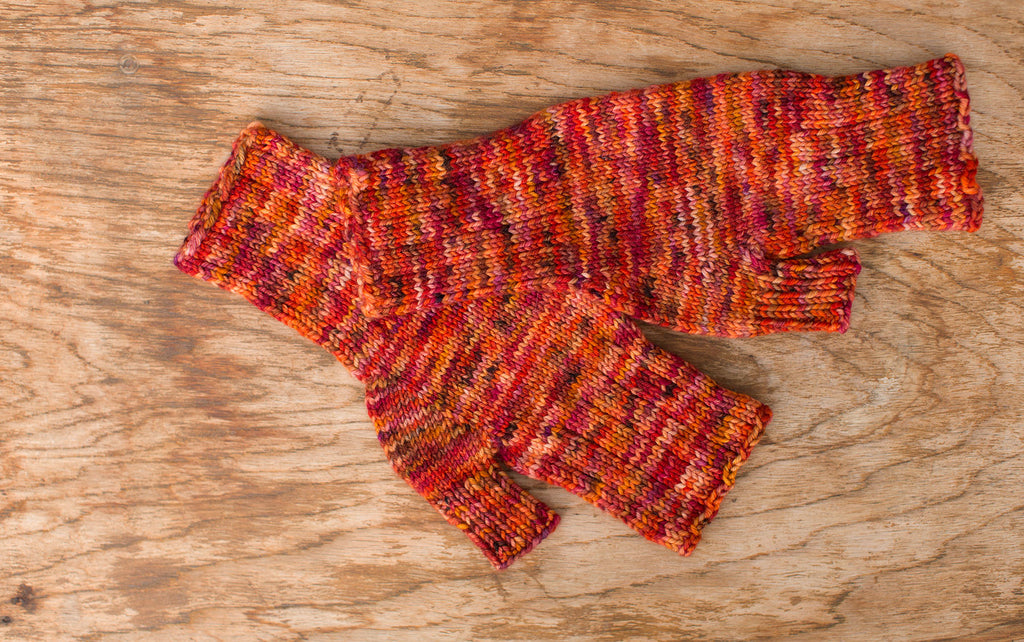 Vibrant multi-color orange, red, and yellow fingerless gloves. Handmade by the TOM BIHN Ravelry group for the TOM BIHN crew.