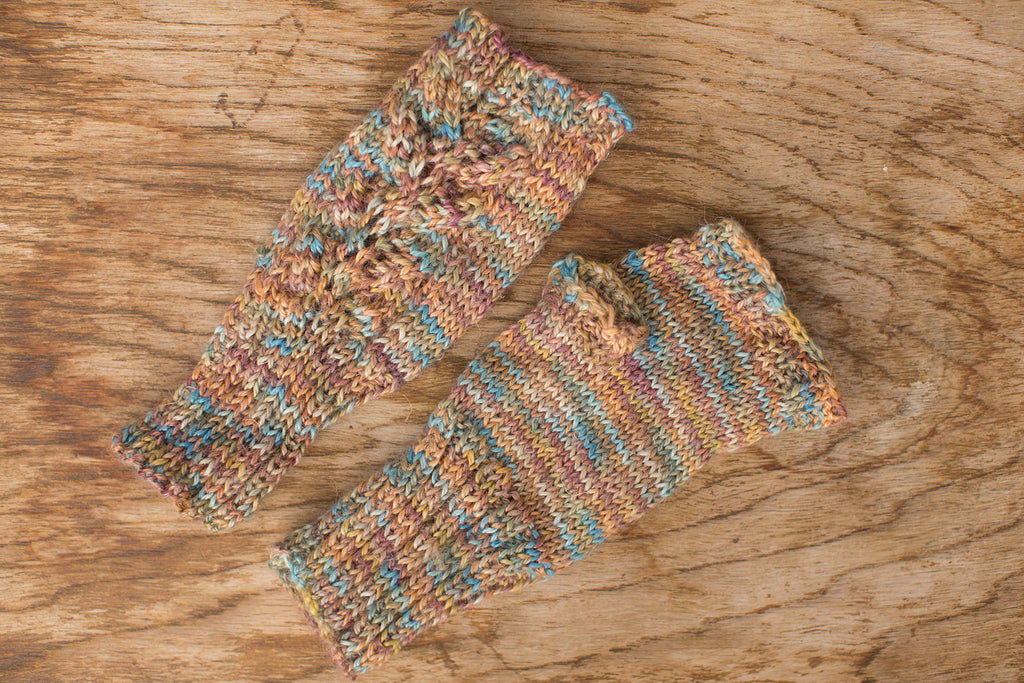 Pale yellow, blue, pink, multicolor fingerless gloves. Handmade by the TOM BIHN Ravelry group for the TOM BIHN crew.