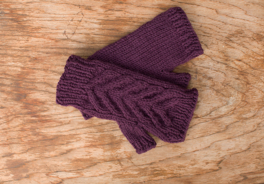 Rich purple fingerless gloves. Handmade by the TOM BIHN Ravelry group for the TOM BIHN crew.