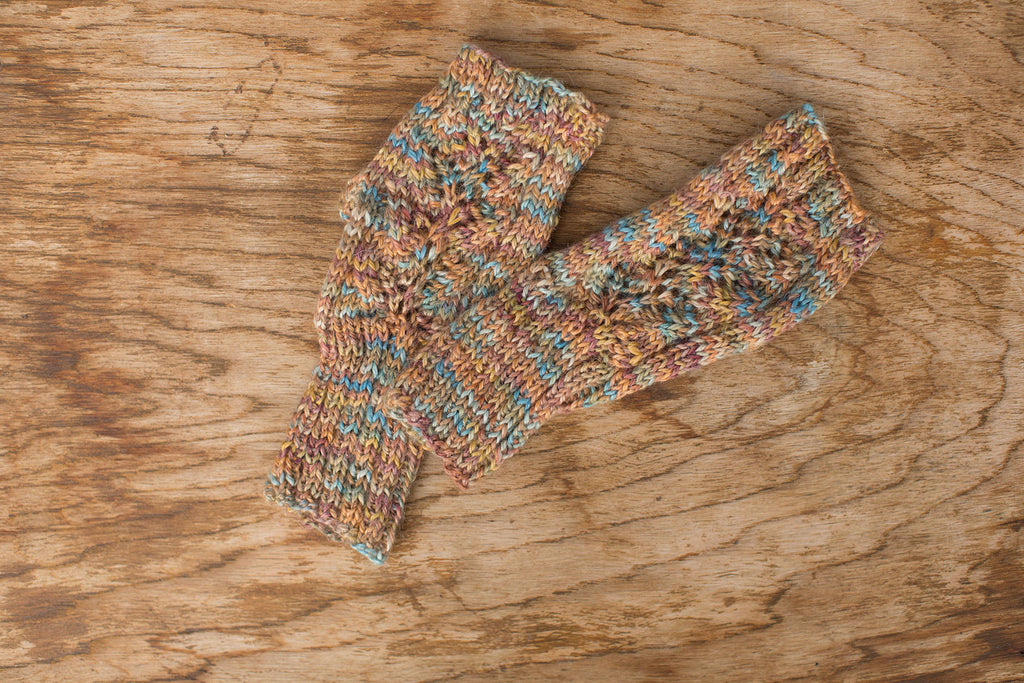 Multicolor knit fingerless gloves. Handmade by the TOM BIHN Ravelry group for the TOM BIHN crew.