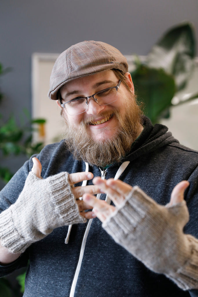 Matthew with his fingerless gloves. He often wears his 2017 knitted hat to work.
