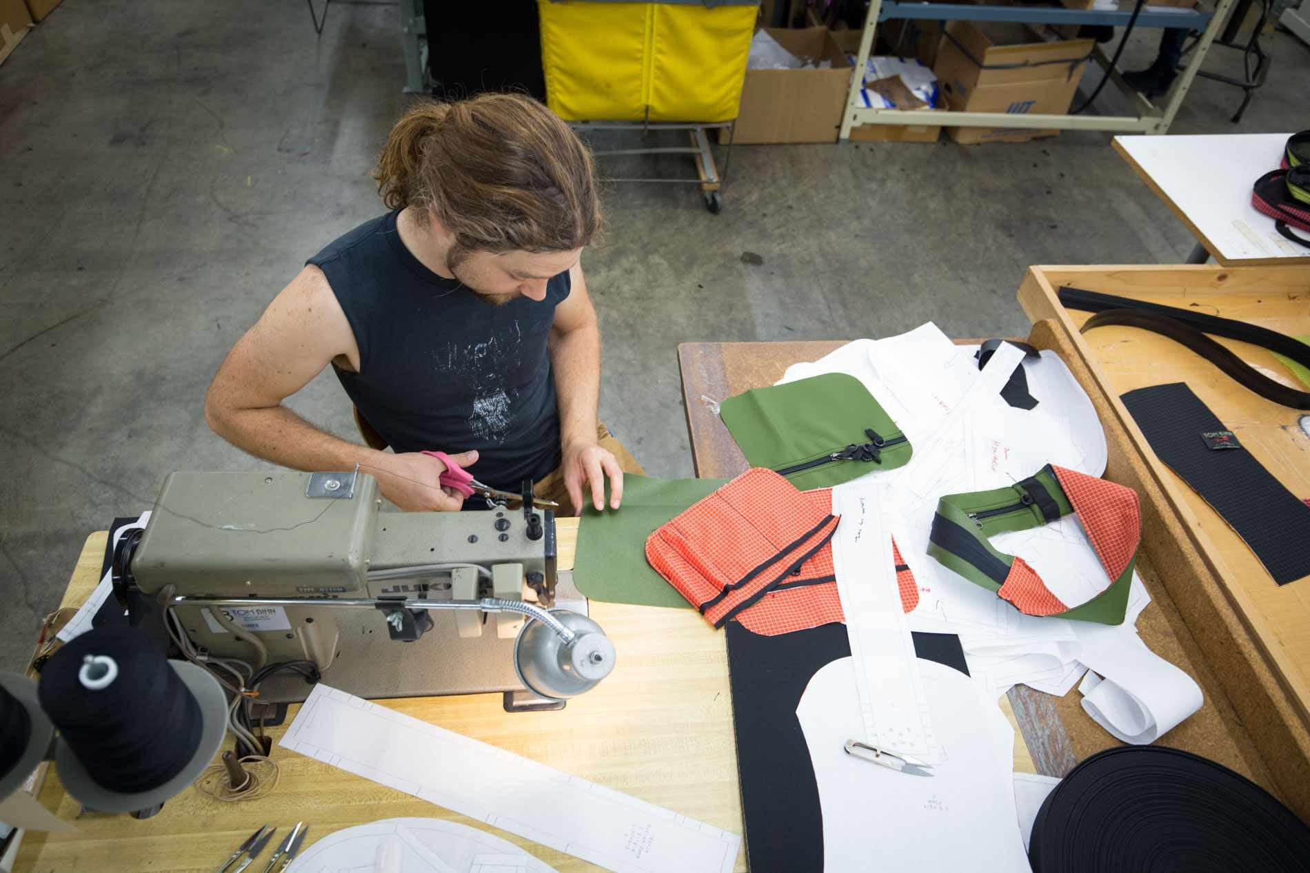 Nik cutting a notch into a piece of fabric during prototyping