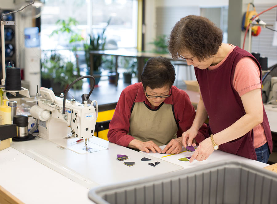 Lisa and Chun inspecting fabric parts.