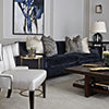 Formal living room with navy blue velvet sofa and white occasional chair